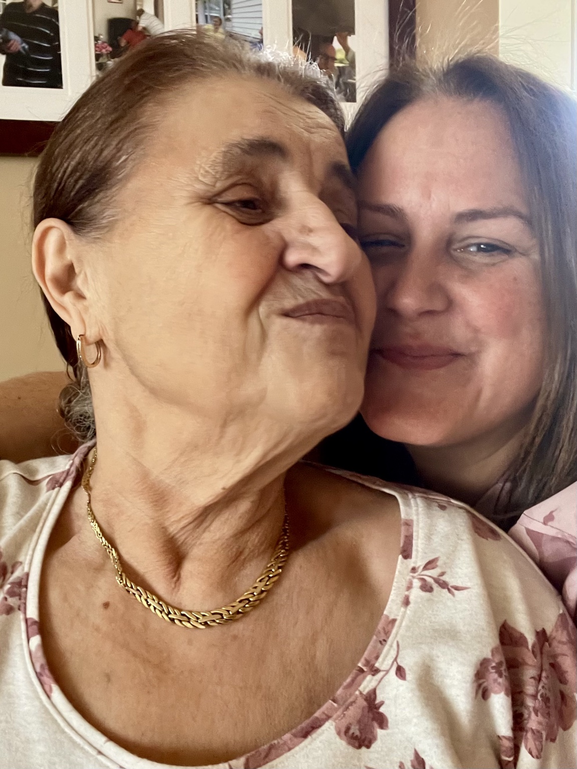 Rosa and Christine smiling together at home